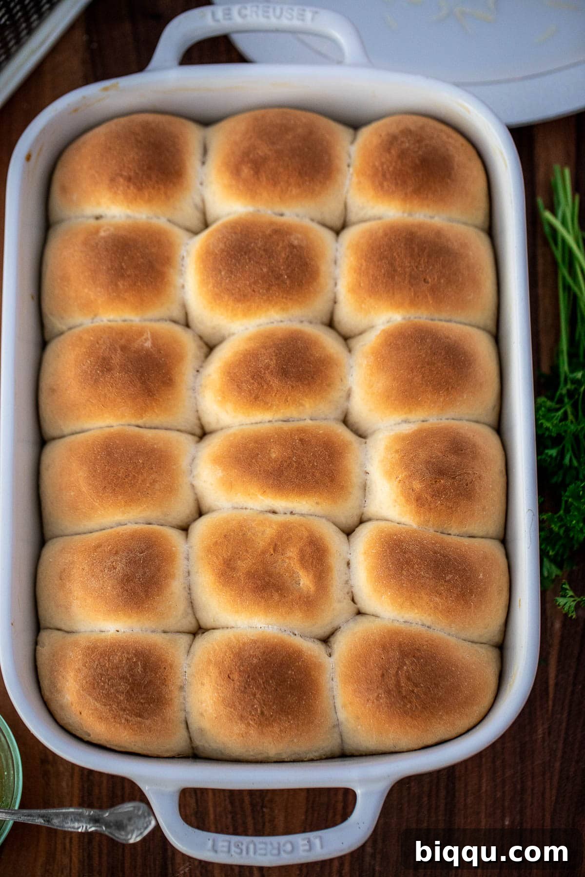 Golden-brown baked rolls freshly out of the oven, still in the baking dish.