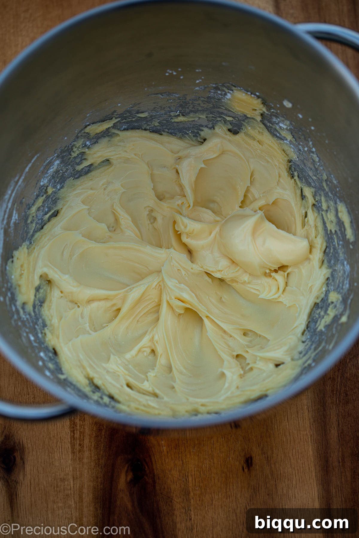 Softened butter and powdered sugar being creamed together in the bowl of a stand mixer.