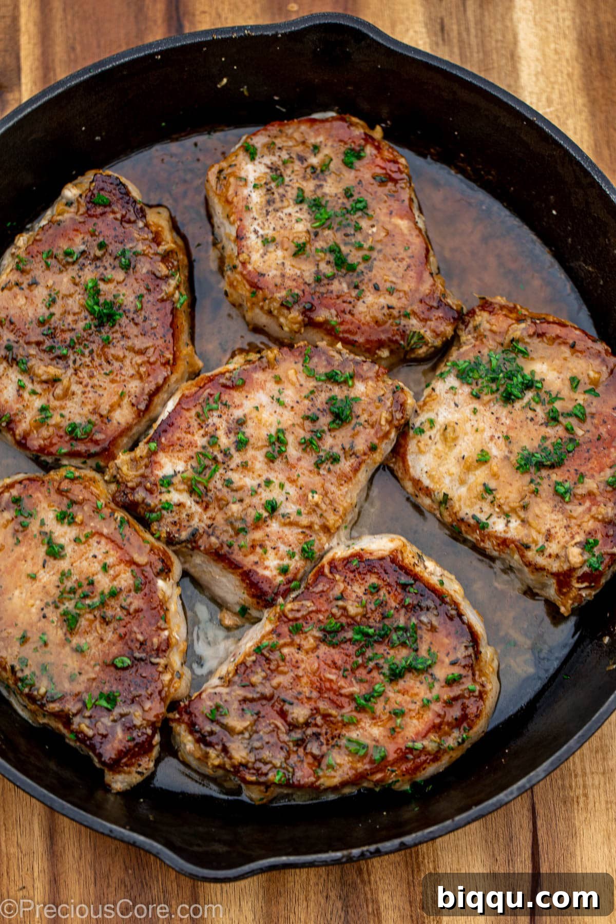 Cooked pork chops in butter sauce.