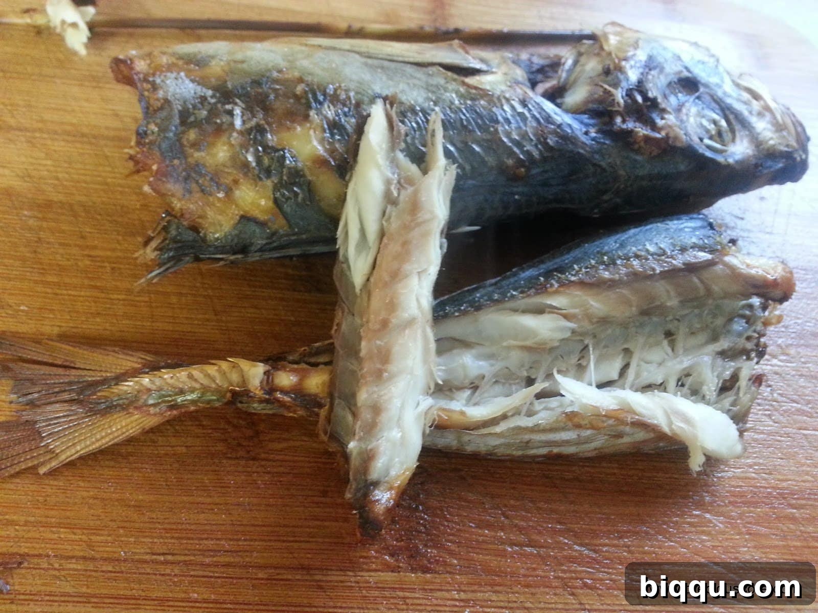 A piece of dried fish broken off for a taste test.