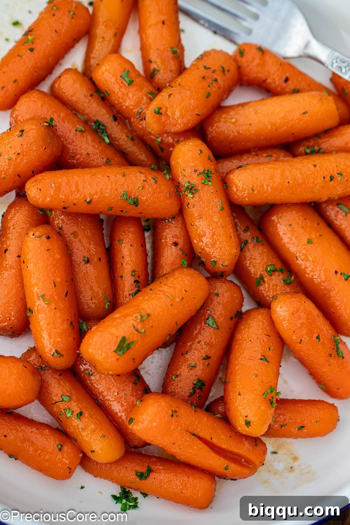 Brown sugar honey glazed carrots on a plate, ready to be served.