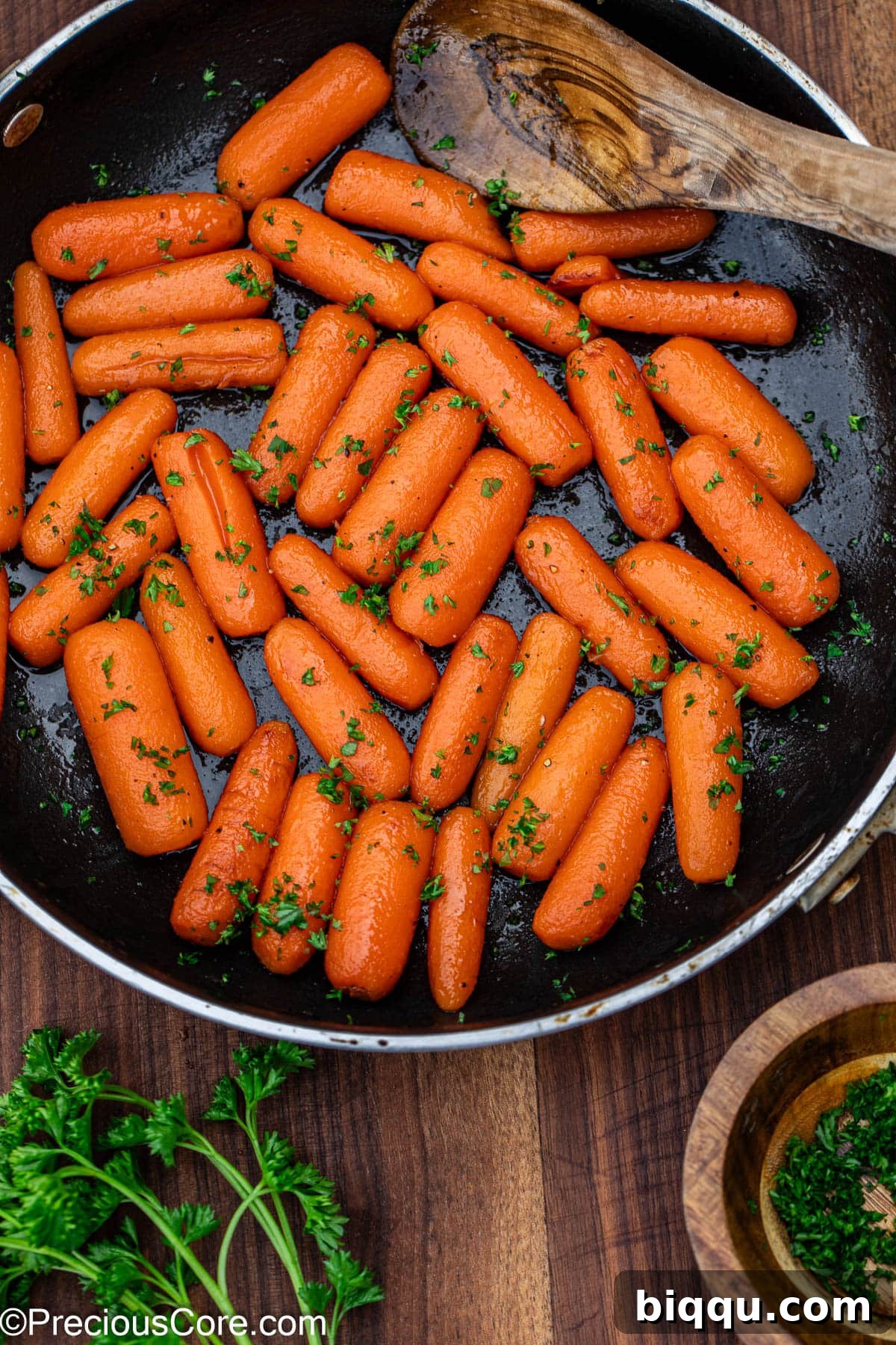 Perfectly glazed carrots garnished with a generous sprinkle of fresh parsley.