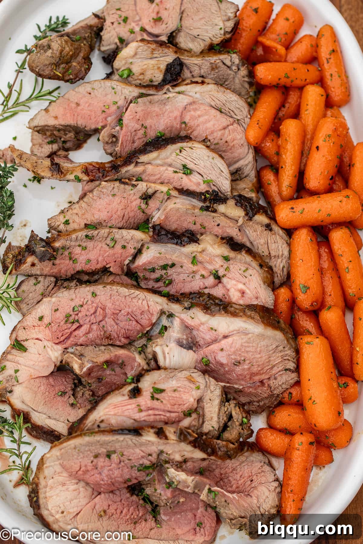 A serving platter featuring delicious lamb alongside a vibrant portion of glazed carrots.
