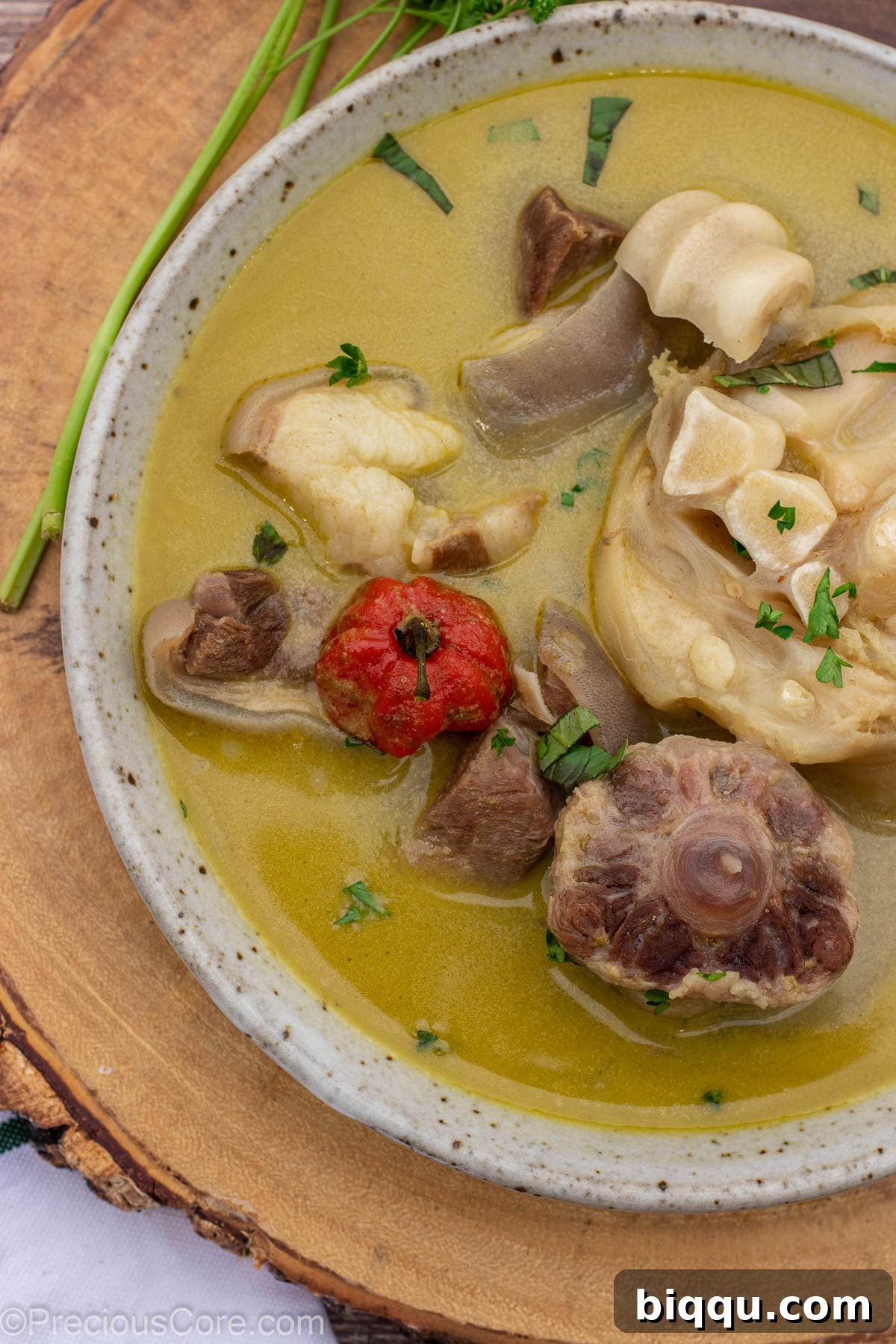 A closer view of the pepper soup in a bowl, showcasing the tender meat chunks and rich broth.
