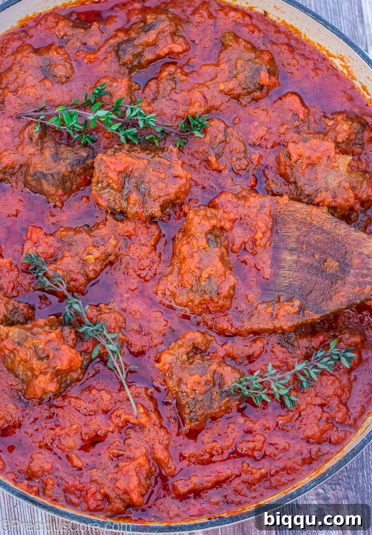 Big pot of rich, red tomato beef stew, ready to serve.