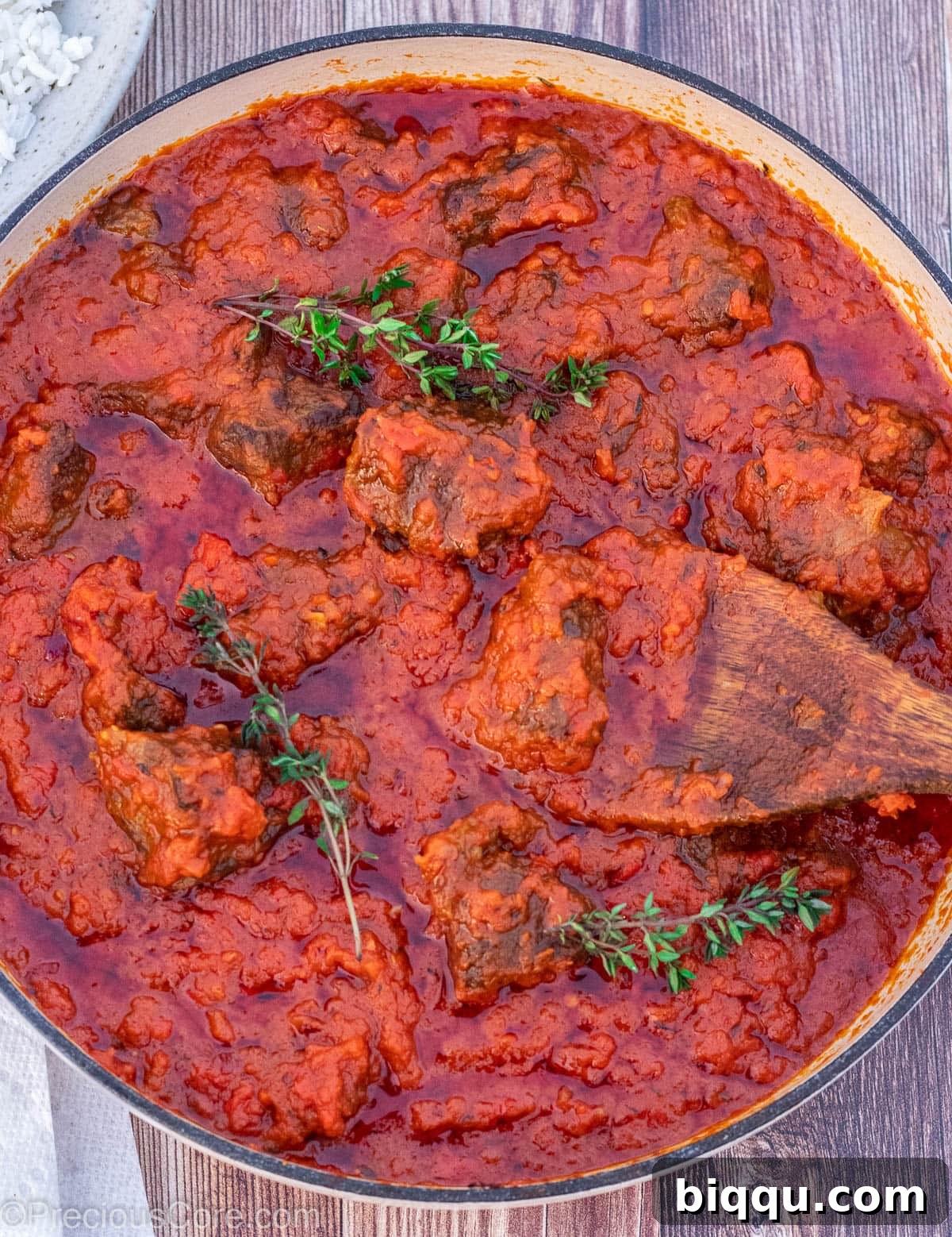 A shallow pot of Nigerian Beef Stew, glistening with rich flavors.