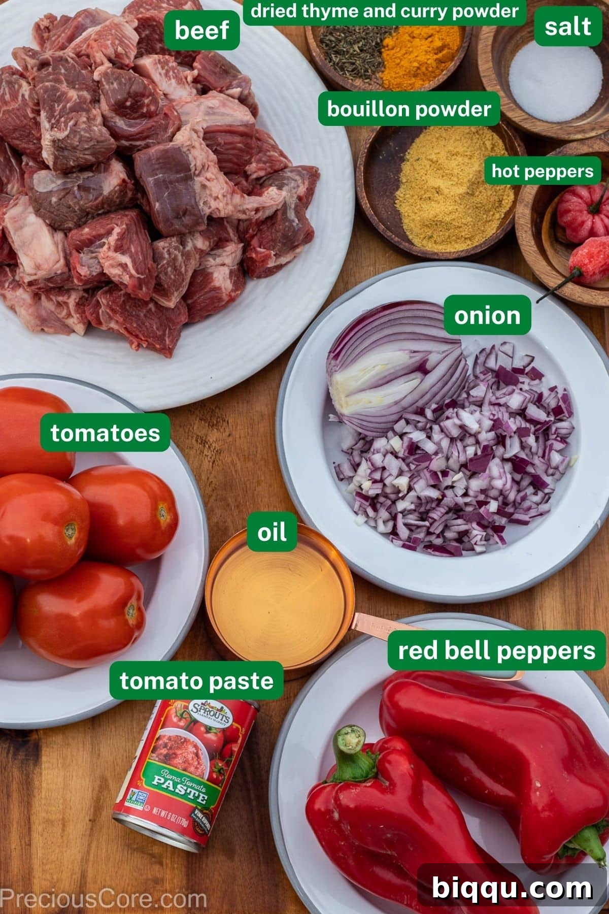 Labeled ingredients for Nigerian Beef Stew laid out on a surface.