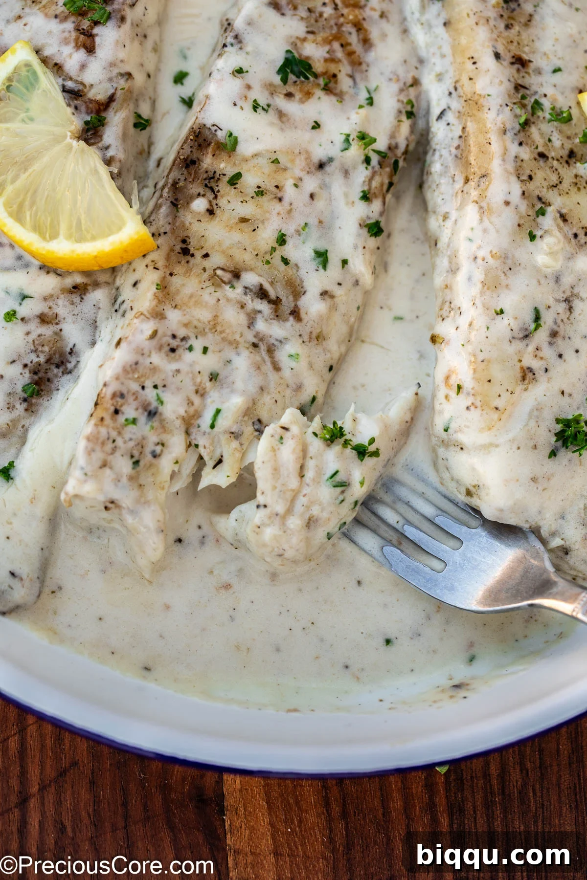 Silken Fish Delight 13 A fork gently separates a piece of cooked fish, demonstrating its perfect flakiness and tenderness.
