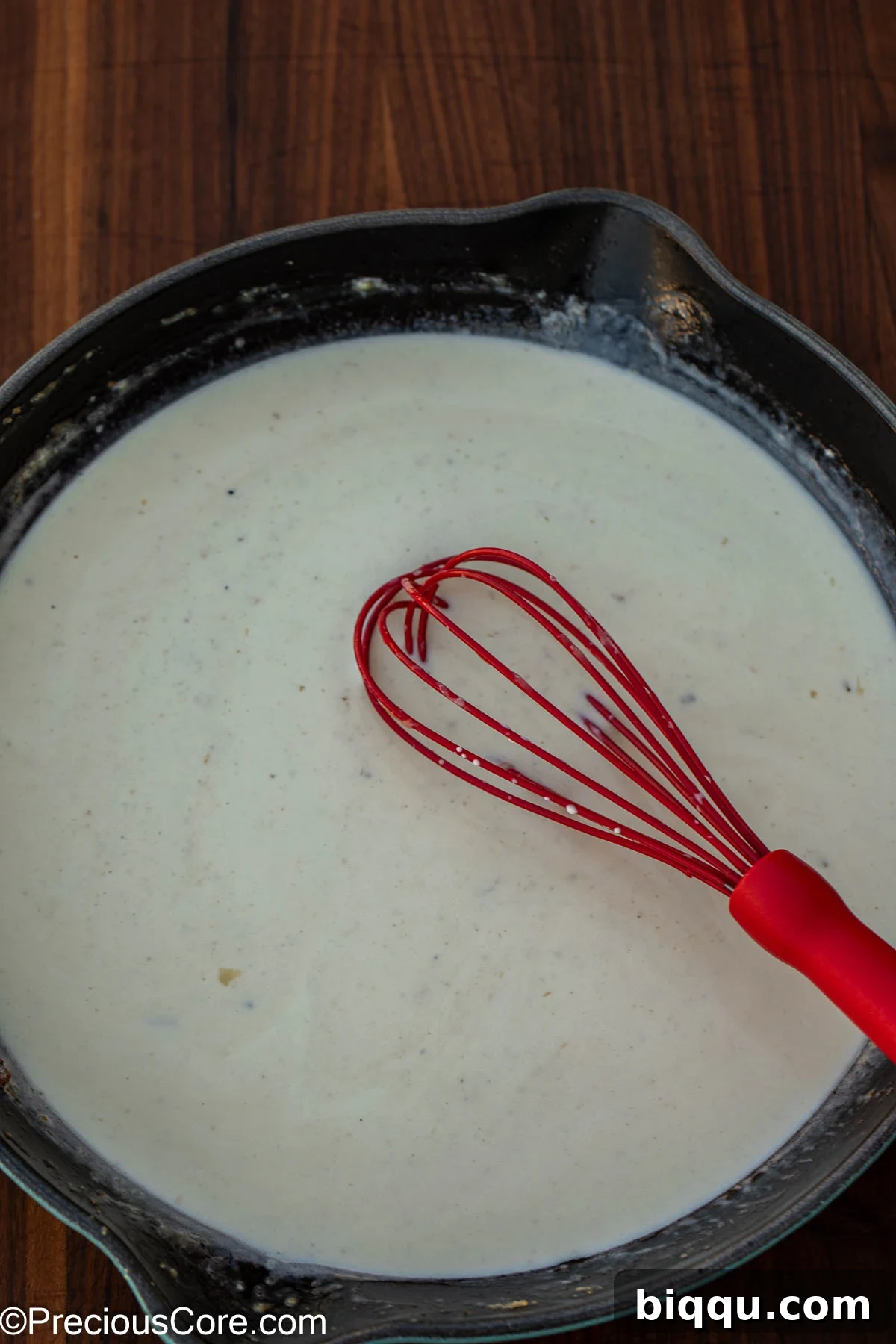 Silken Fish Delight 9 Rich, creamy white sauce simmering gently in a pan, ready for the fish to be added back.