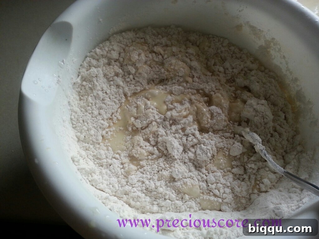 Adding eggs and coconut milk to dry ingredients