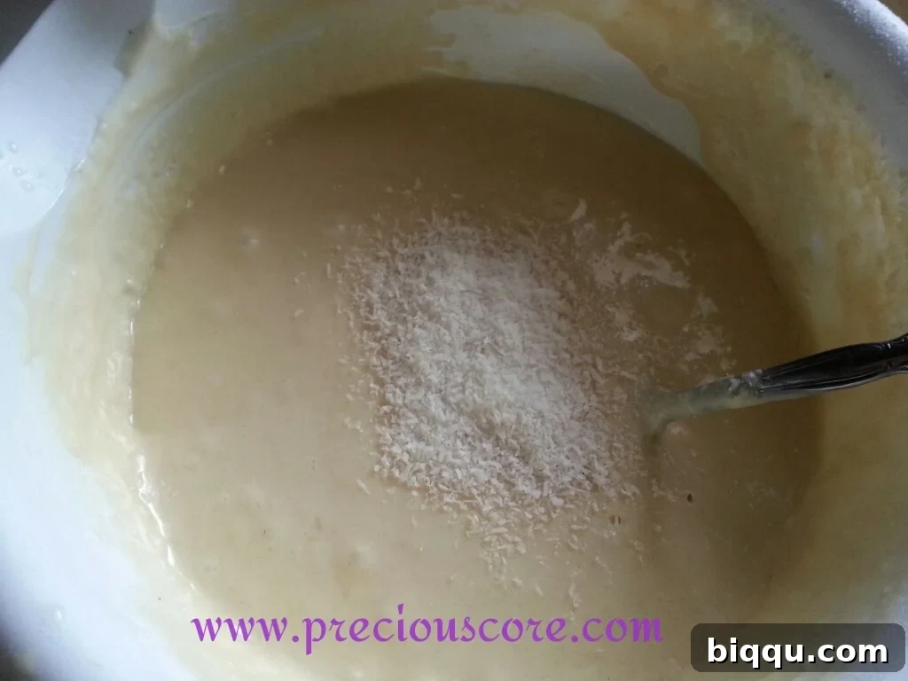 Folding shredded coconut into pancake batter