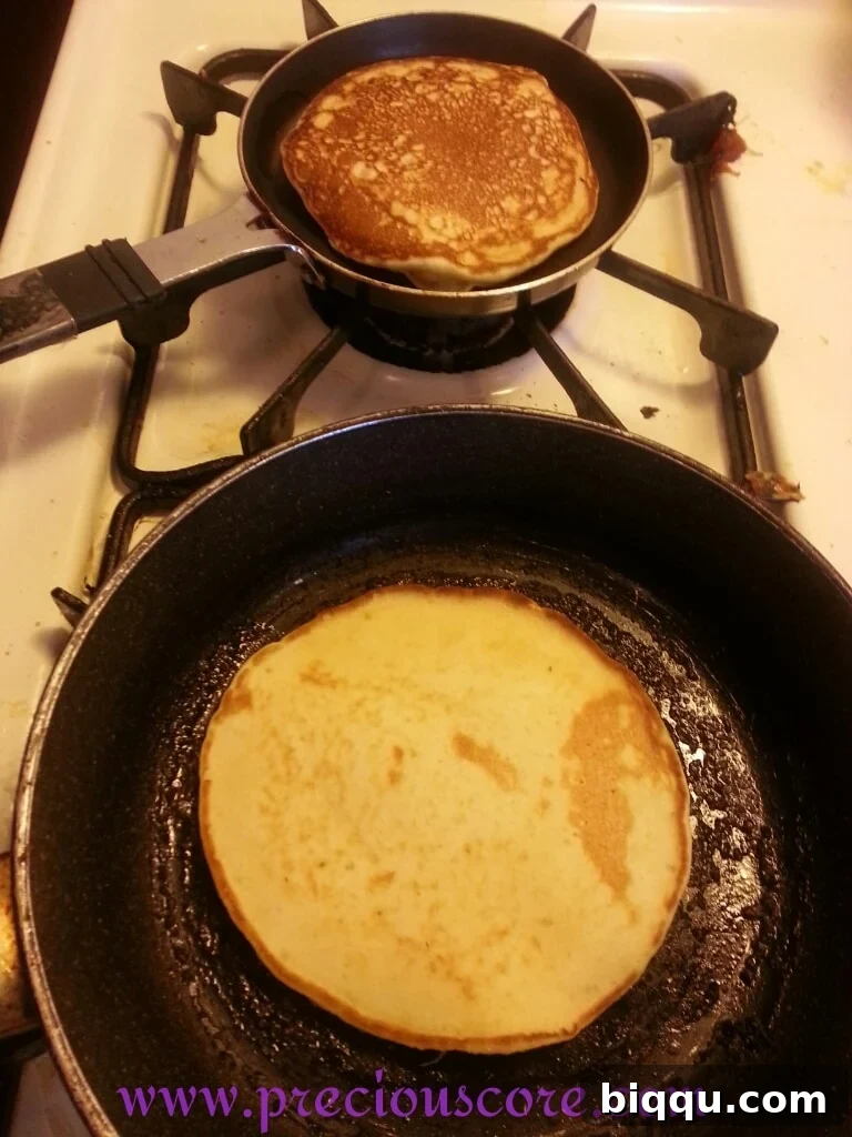 Flipping a coconut pancake on the skillet