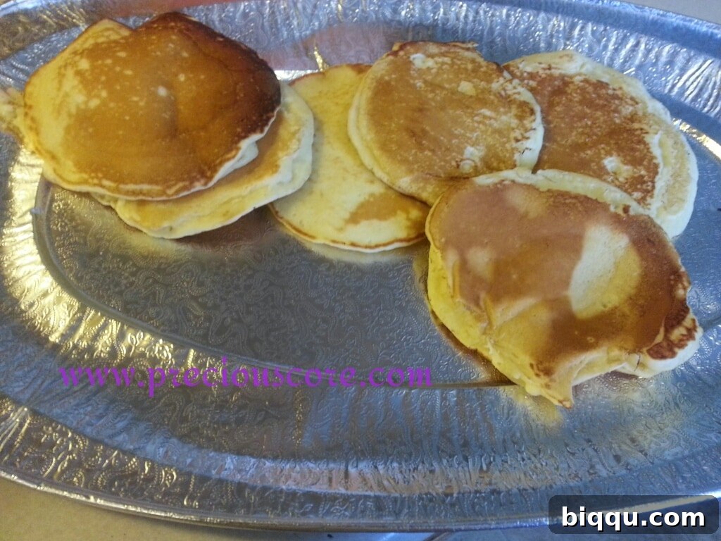 Stack of fluffy coconut pancakes with syrup