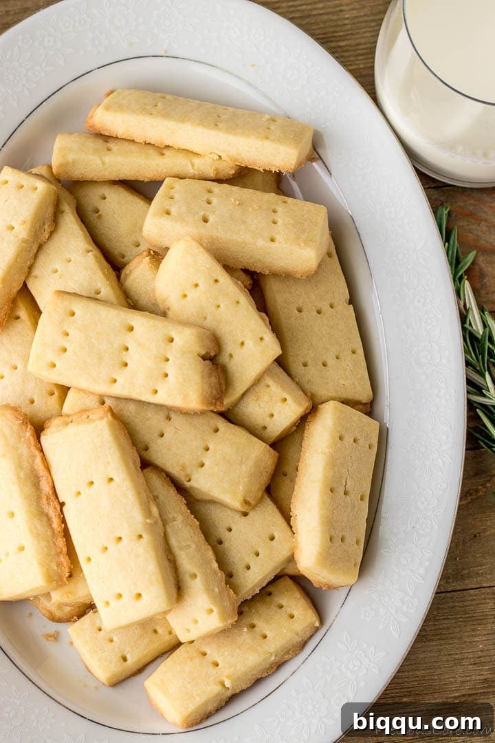 Effortless Homemade Shortbread 2 Shortbread Cookies on a platter with milk on the side