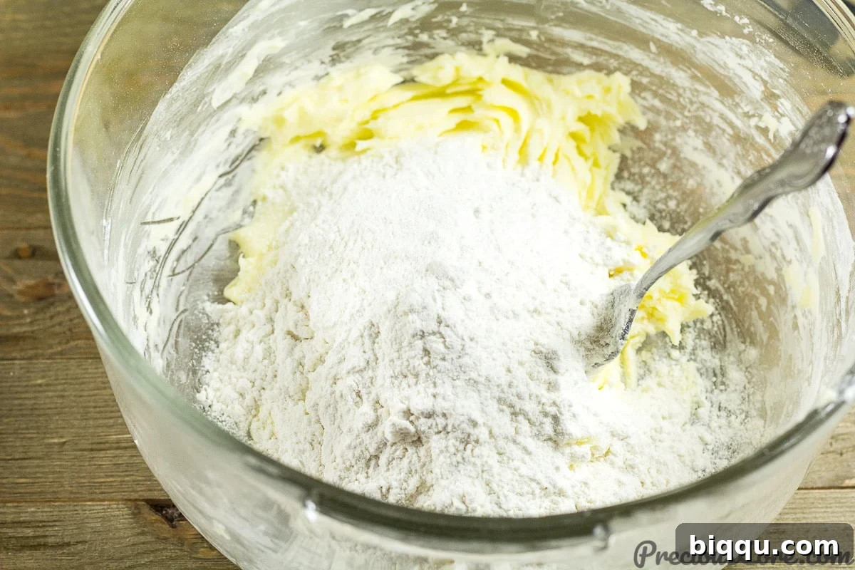 Effortless Homemade Shortbread 8 Adding flour to butter and sugar.