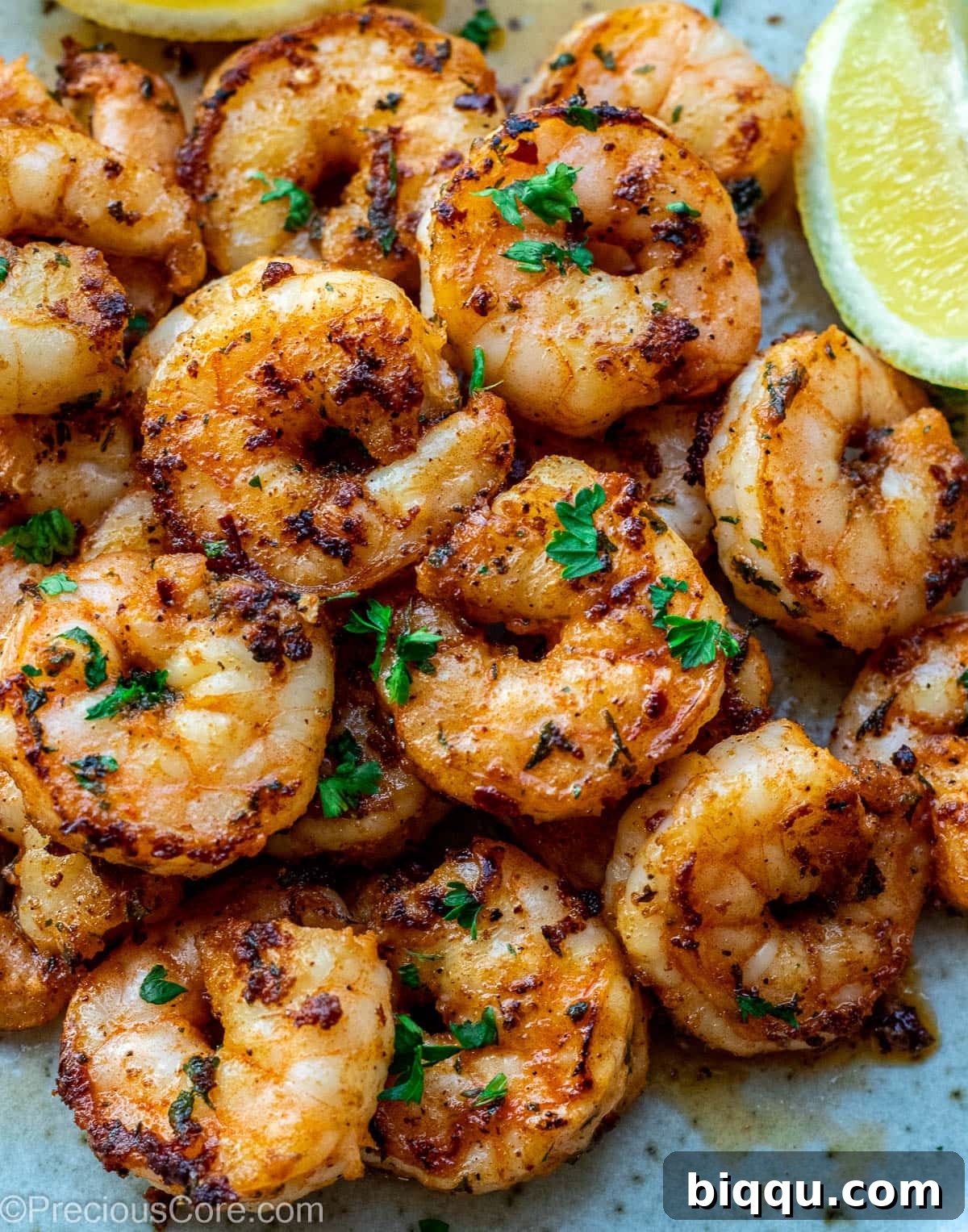 Exquisitely pan-seared shrimp, golden-brown and juicy, arranged artfully on a plate, ready to be enjoyed.
