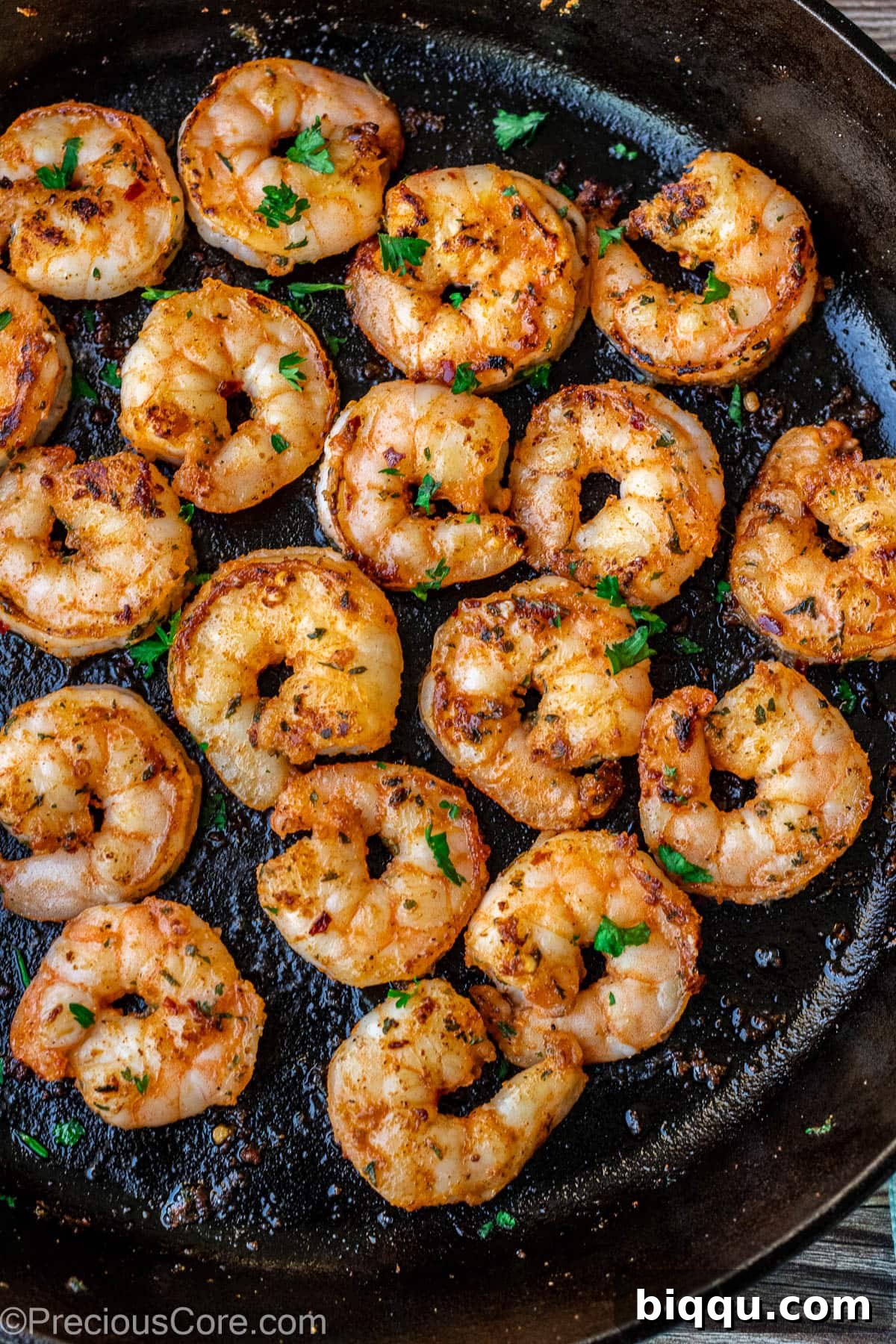 Succulent pan-seared shrimp sizzling to perfection in a hot skillet, showcasing their delicious golden crust.