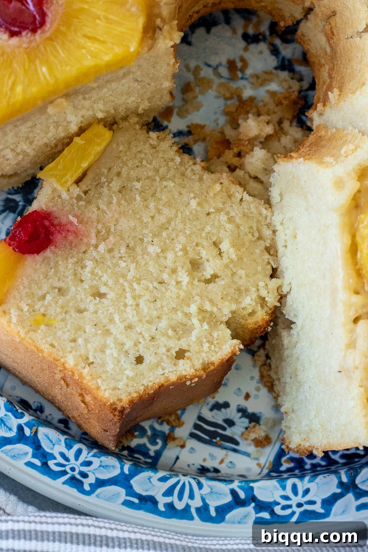 A generous slice of Pineapple Upside Down Pound Cake presented on a blue tray, ready to be enjoyed.