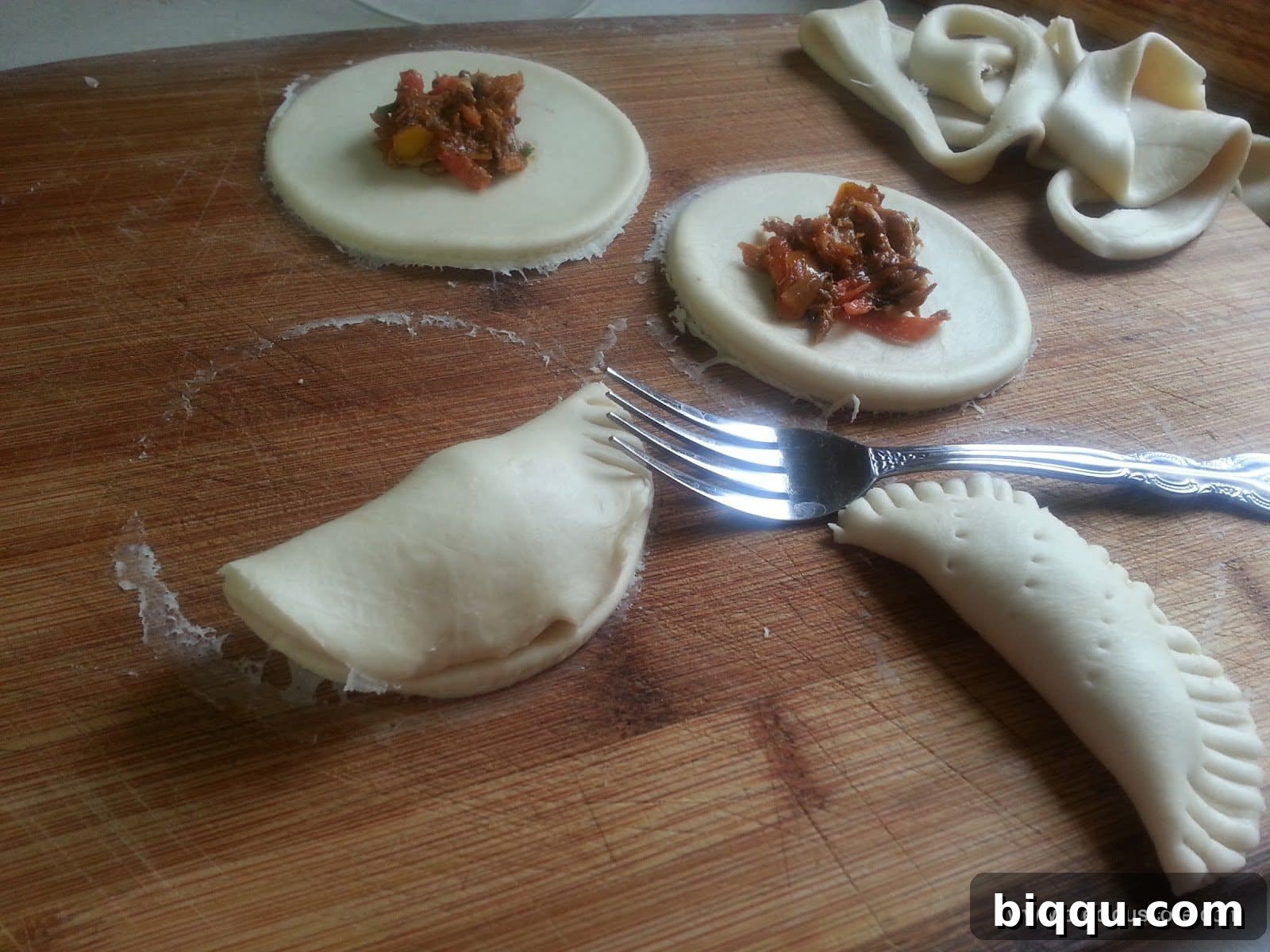 Assembled fish pies with crimped edges and poked holes, ready for baking