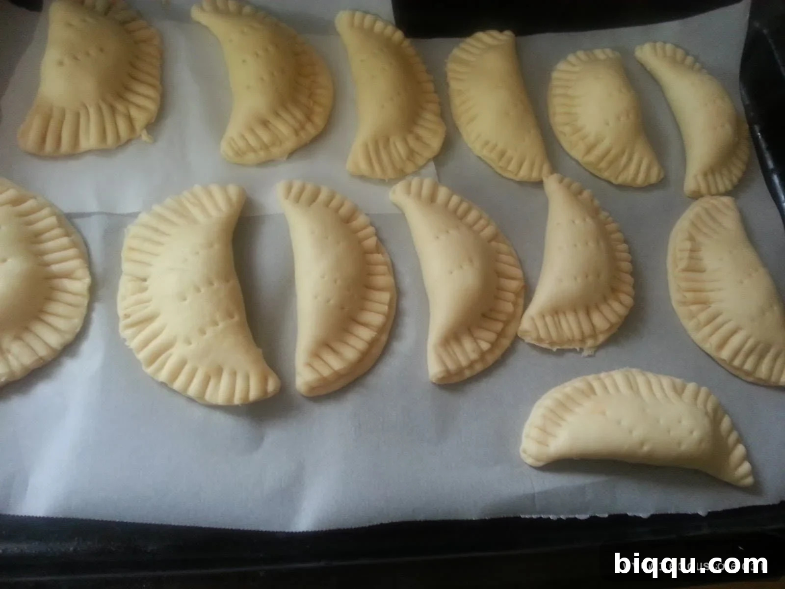 Assembled fish pies placed on a baking tray, ready for the oven