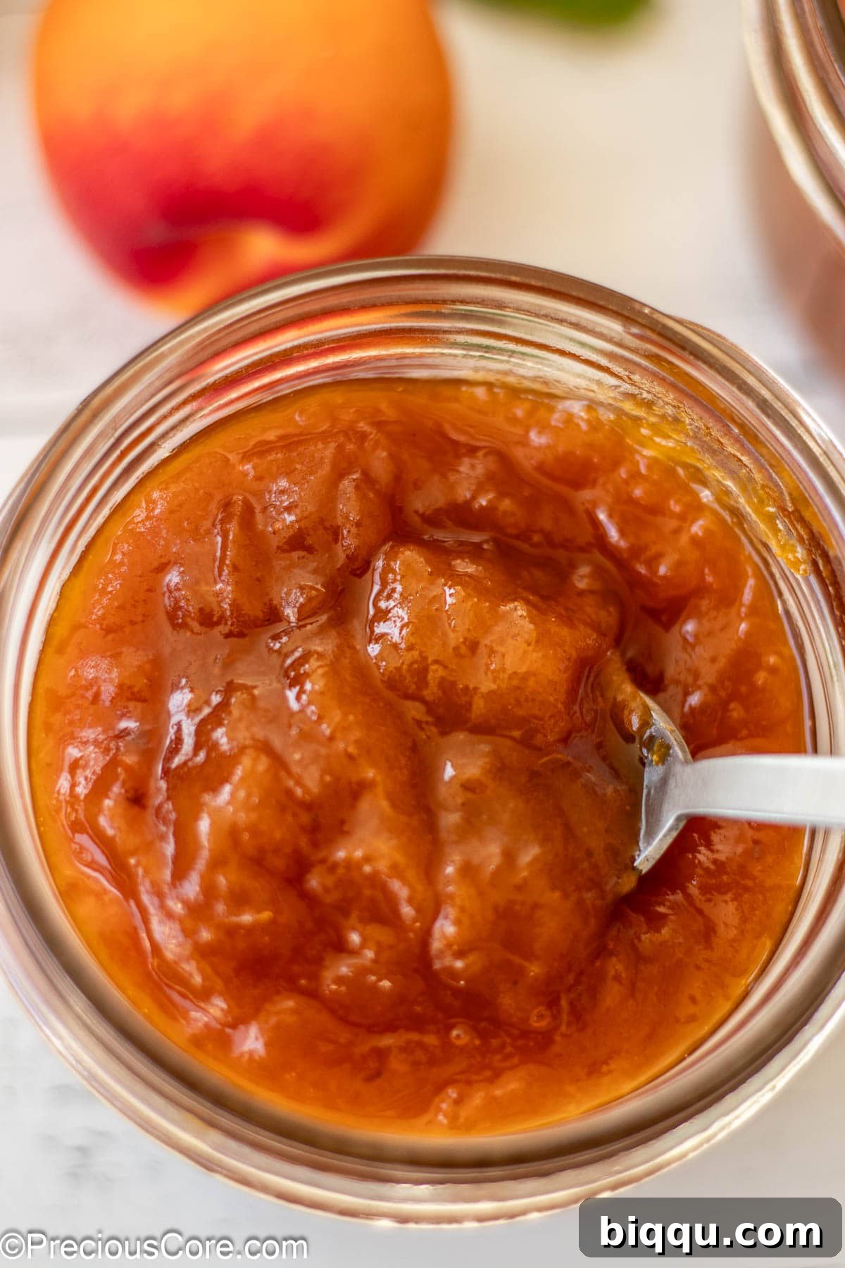 Close-up shot of apricot preserves in a mason jar.