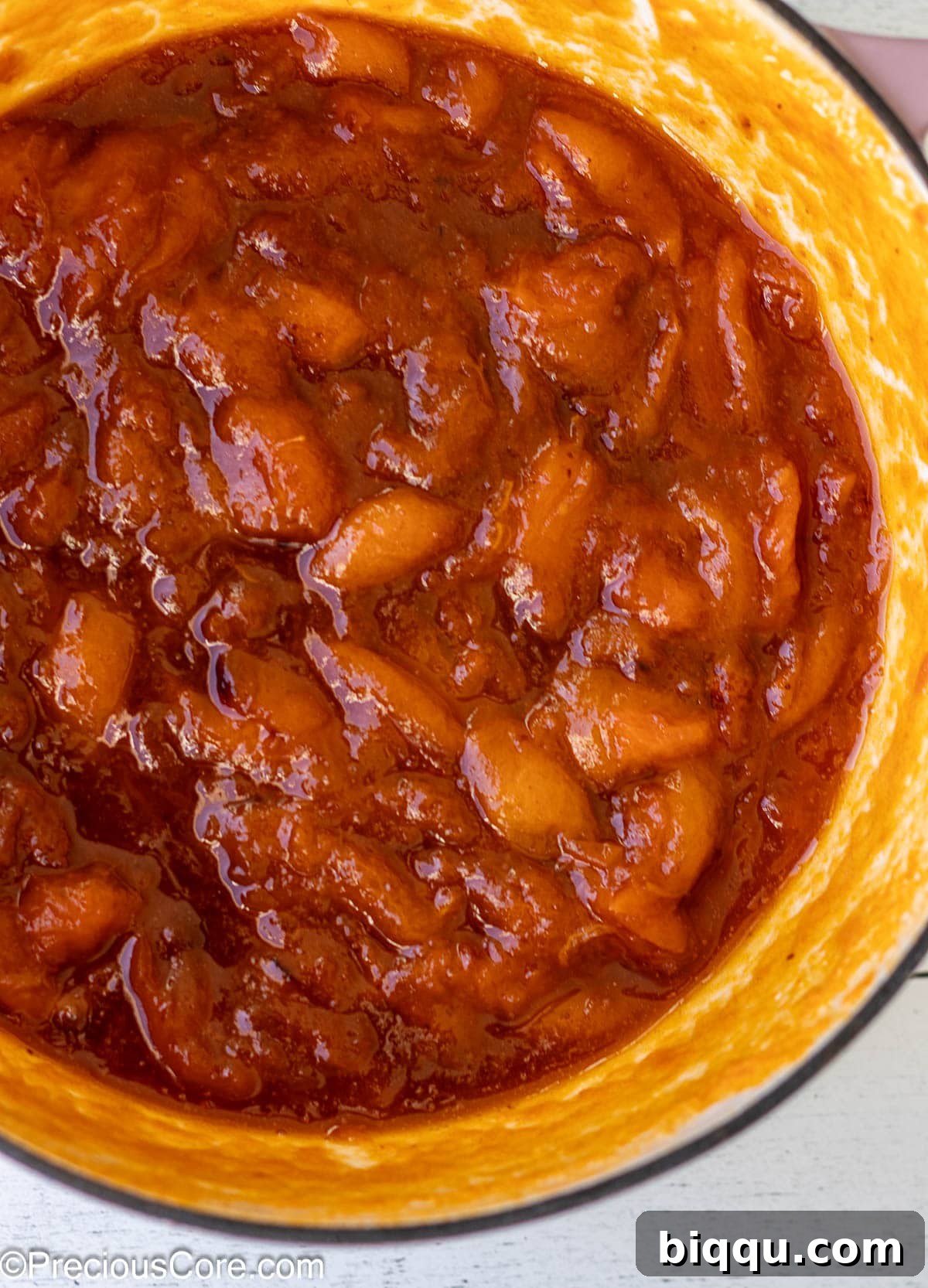 Cooked apricots in an enameled cast iron pot.
