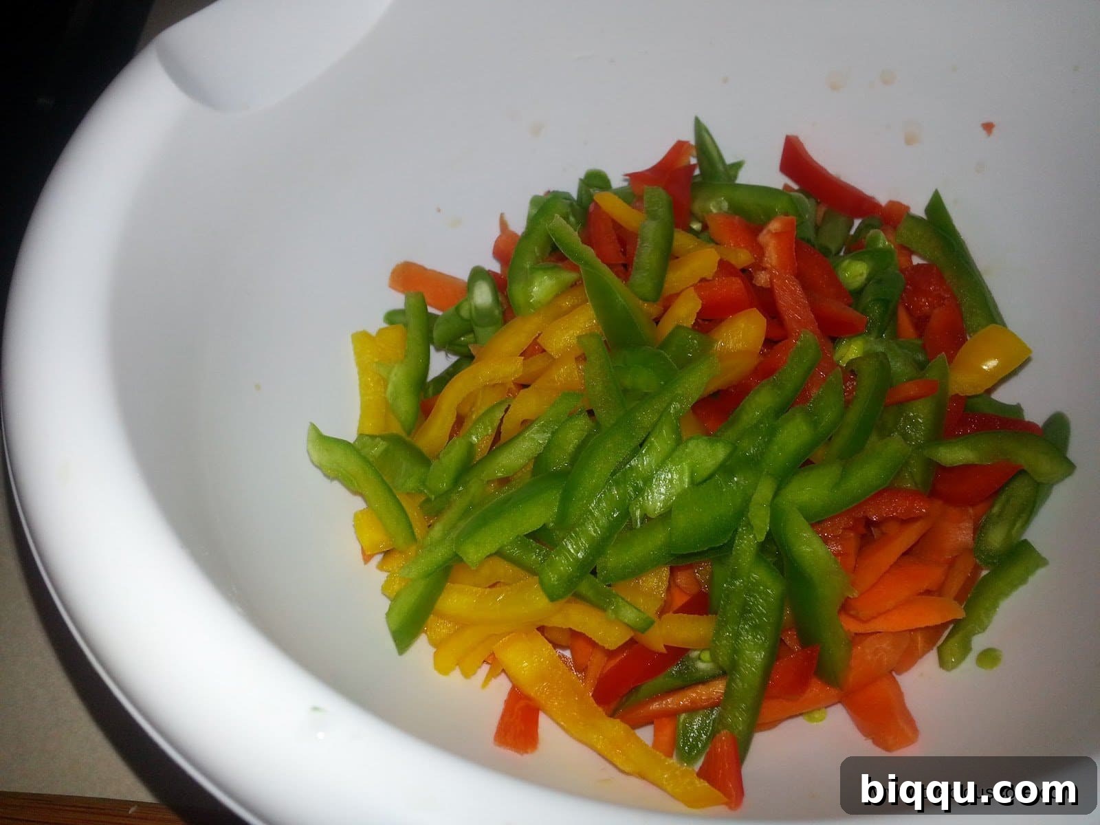Assorted chopped vegetables, including carrots, green beans, and bell peppers, prepped for the stir-fry.
