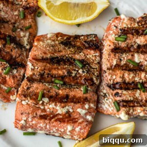 Grilled Sockeye Salmon steaks on a white plate, ready to be served.
