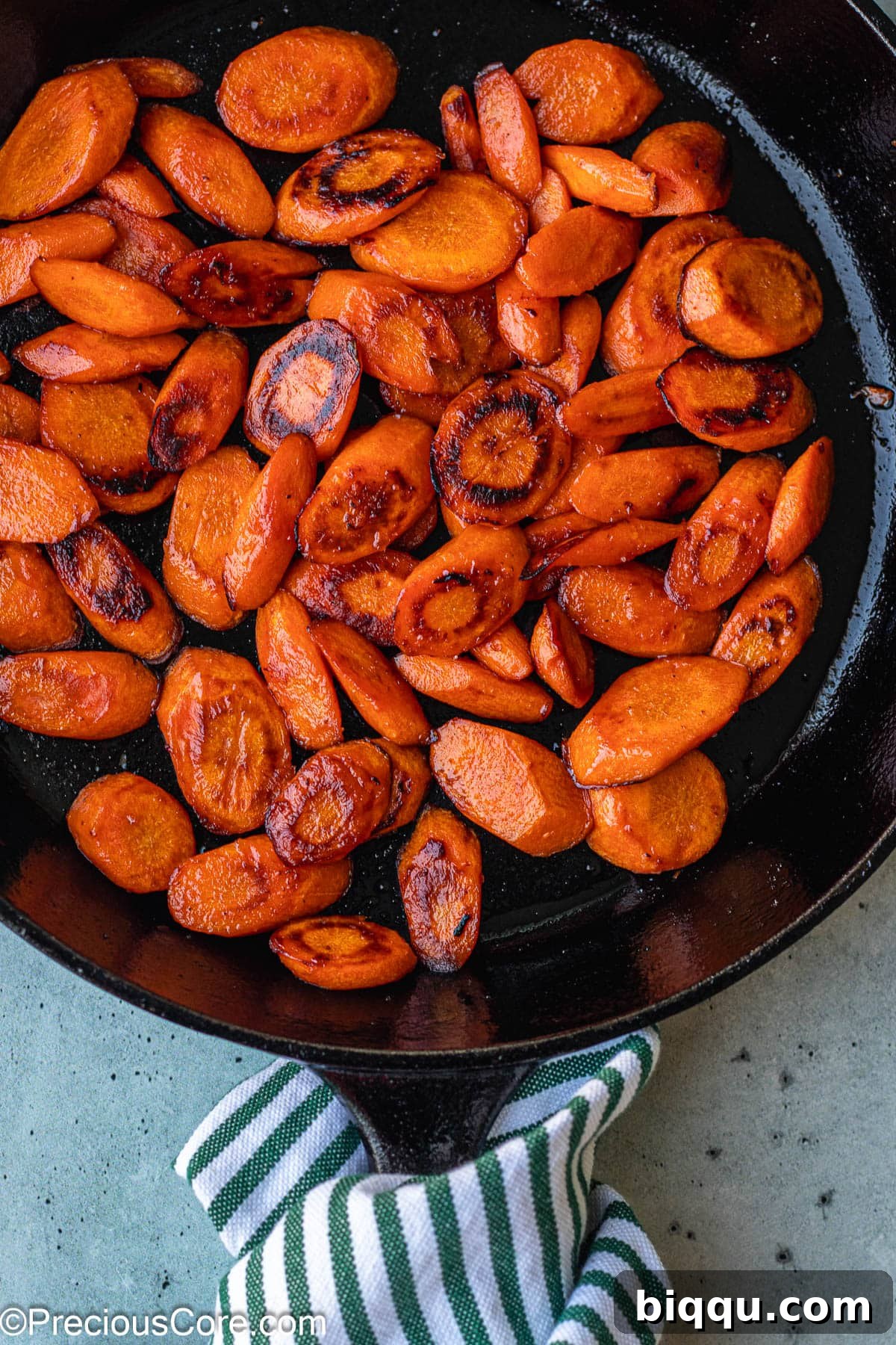 Perfectly cooked Fried Carrots in a Skillet, lightly seasoned and ready to be garnished.