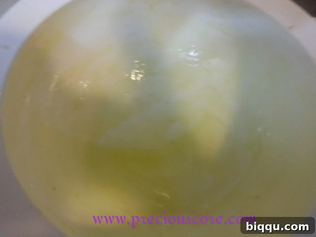 Bread dough placed in an oiled bowl for its first rise, ready for proofing