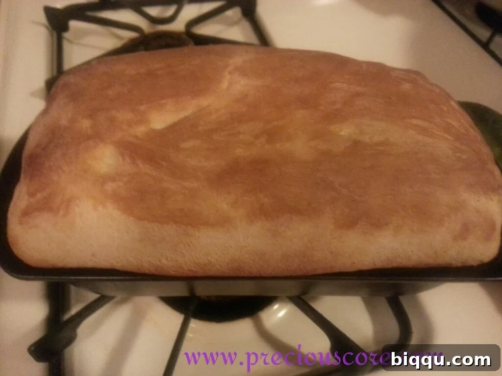Freshly baked Kumba Bread cooling on a wire rack, golden brown and ready to be sliced