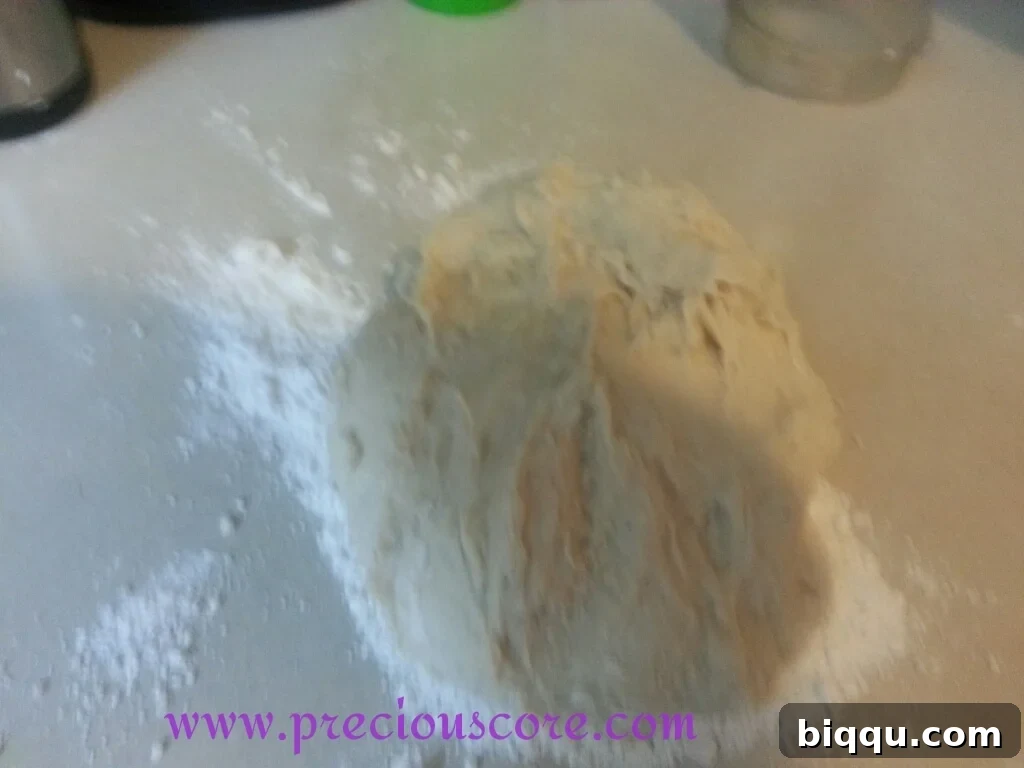 Hands vigorously kneading bread dough on a clean, floured surface