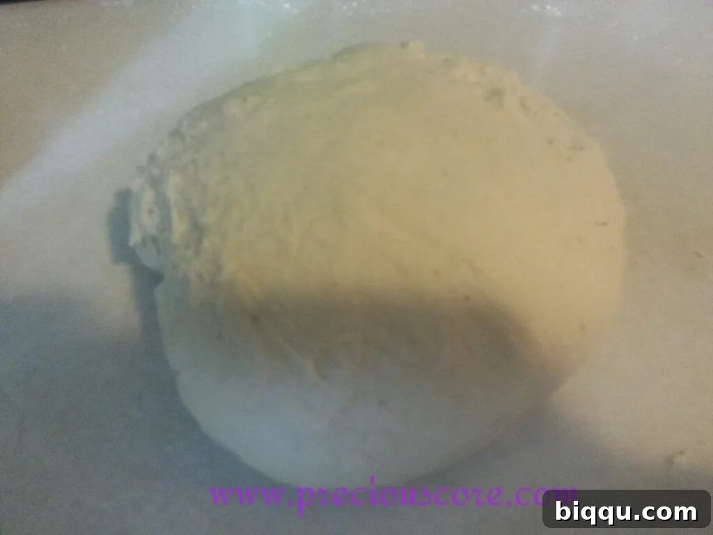 Vegetable oil poured into a mixing bowl, preparing for dough rise