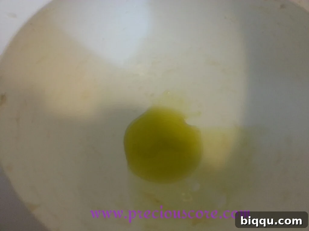 Oil being spread around the inside of a bowl to prevent sticking