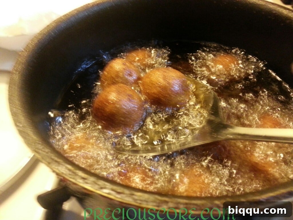 Freshly fried Accra Banana fritters draining on paper towels to remove excess oil