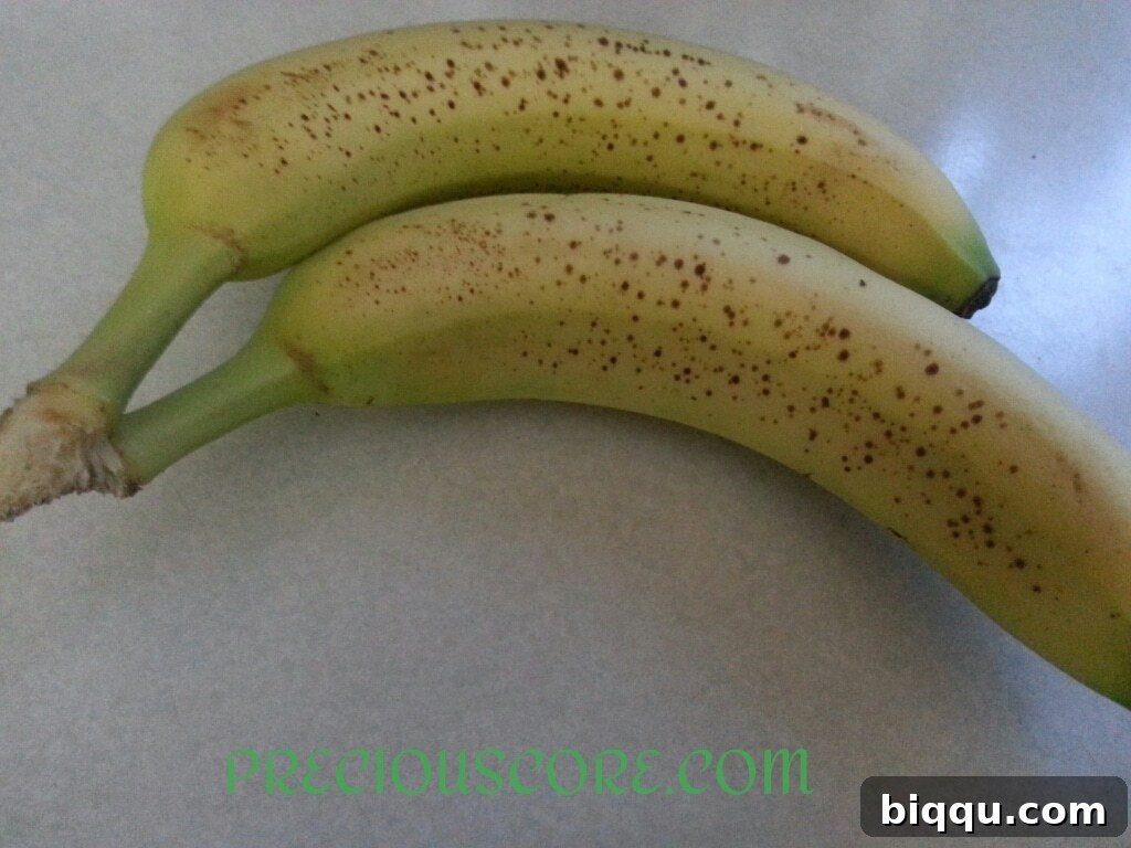 Two very ripe bananas, ideal for making sweet and flavorful Accra Banana fritters