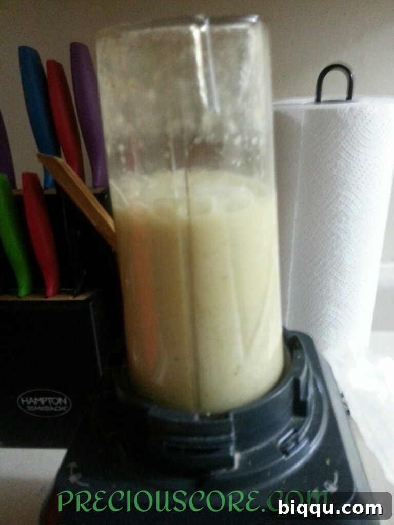 Blended ripe bananas in a blender, forming a smooth paste for the fritter batter