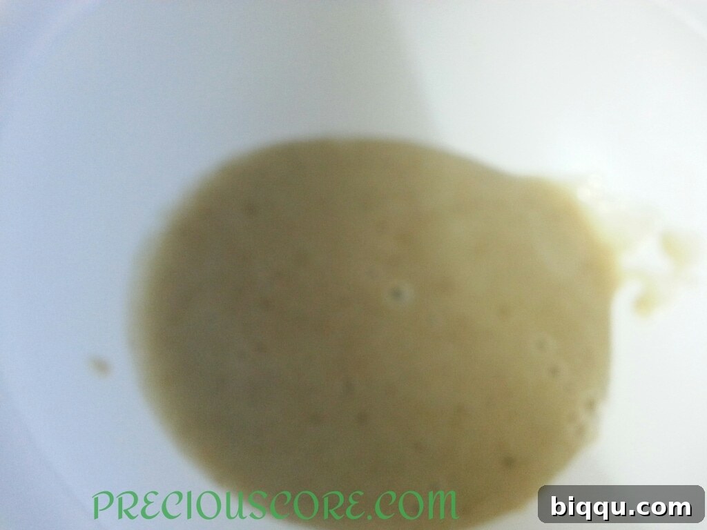 Blended banana mixture in a bowl, ready for the next ingredients