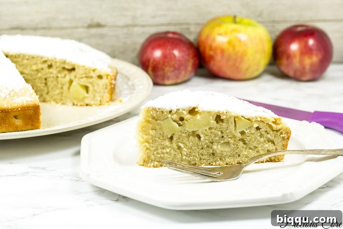 A landscape view of a beautifully baked apple cake, ready to be sliced.