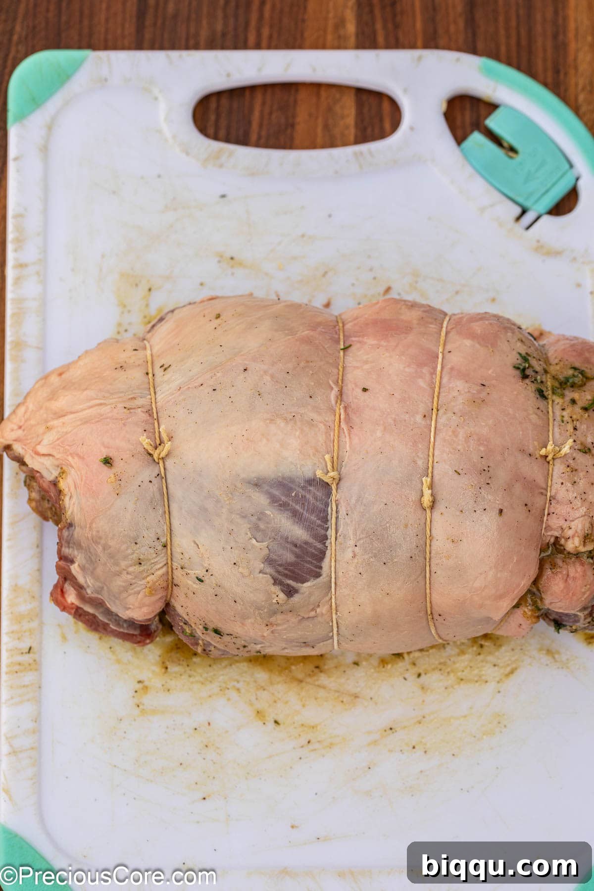 The rolled lamb securely tied with butchers' twine to hold its shape during roasting.