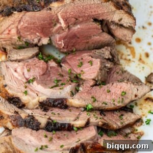 A sliced roasted boneless leg of lamb.