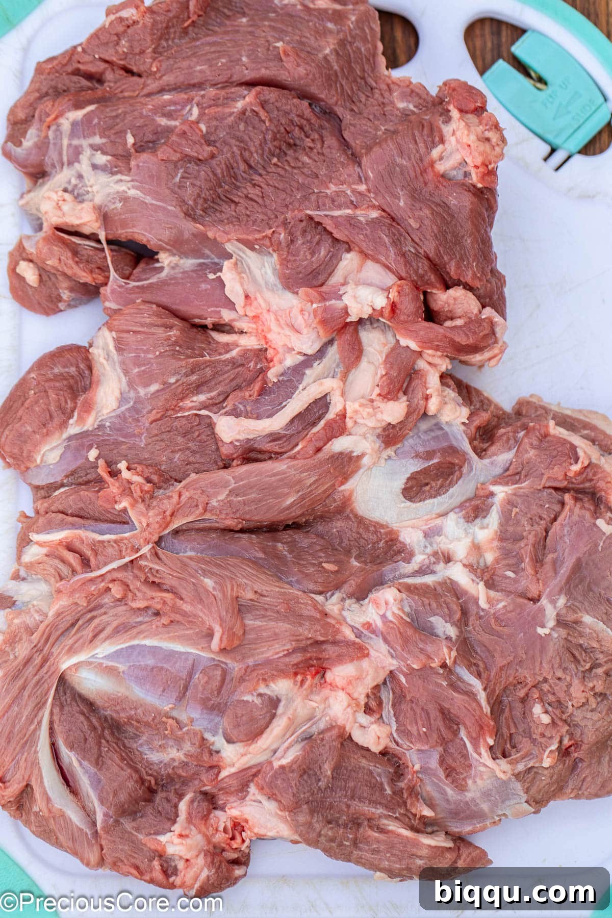 A butterflied leg of lamb, laid flat and ready to be marinated.
