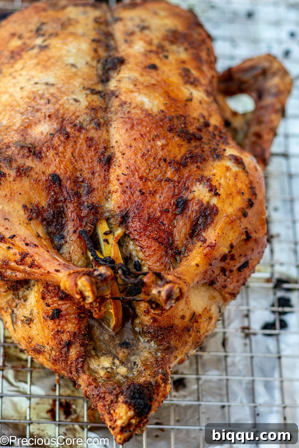 Up close shot of herb-roasted duck, showcasing crispy skin and tender meat.
