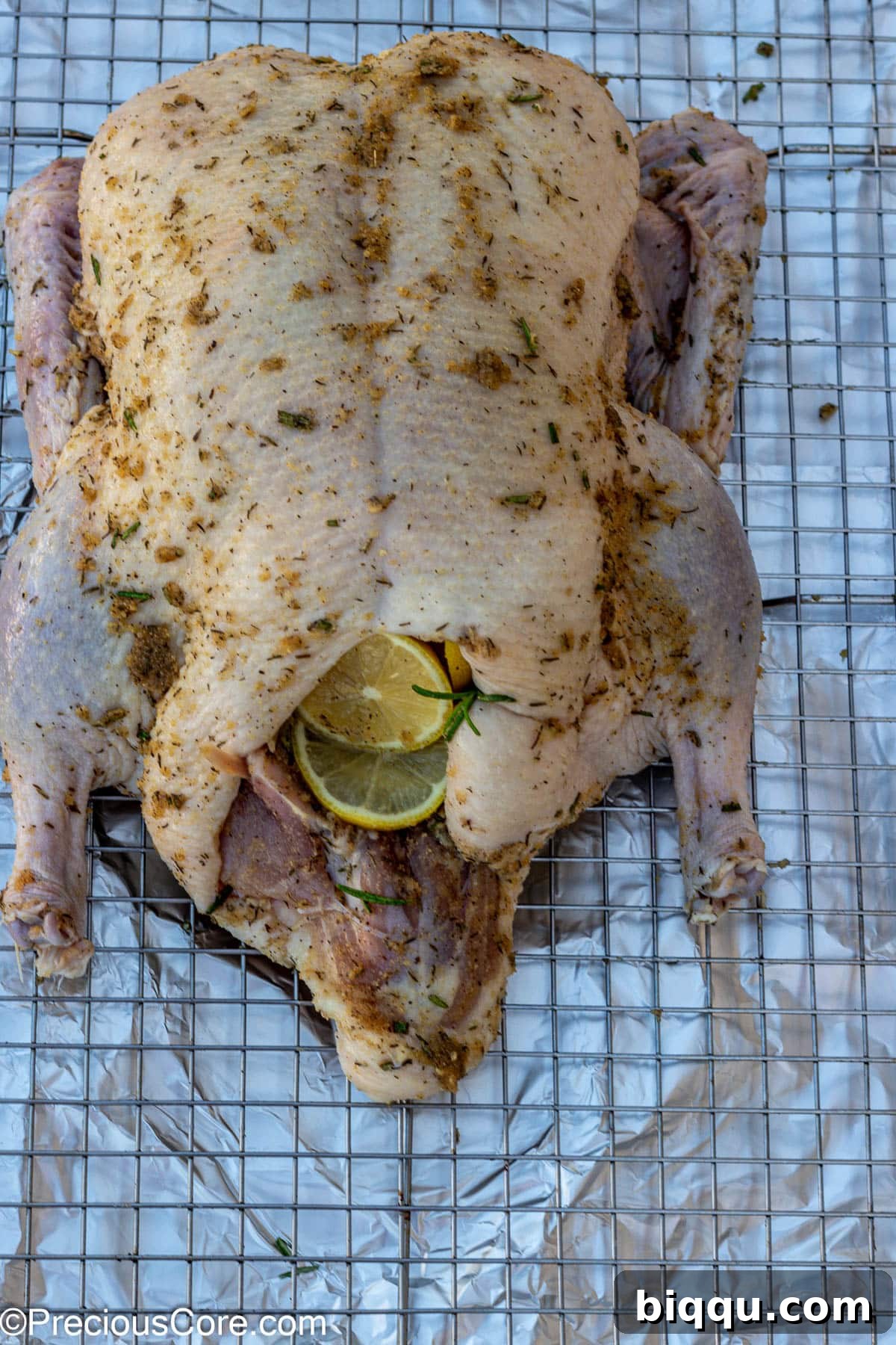 Whole duck seasoned with a generous rub of herbs and spices.