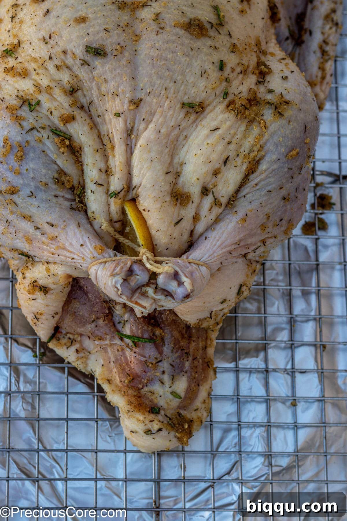 Duck legs tied securely with butcher twine for even roasting.
