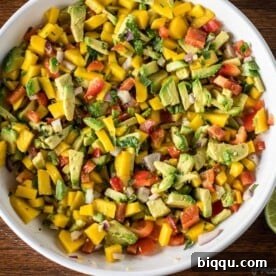 Bright and colorful Mango Avocado Salsa in a white bowl, ready to serve.