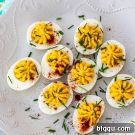 An elegant platter of beautifully decorated deviled eggs.