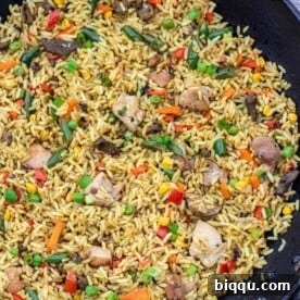 Wok filled with African Fried Rice, a festive and flavorful rice dish.