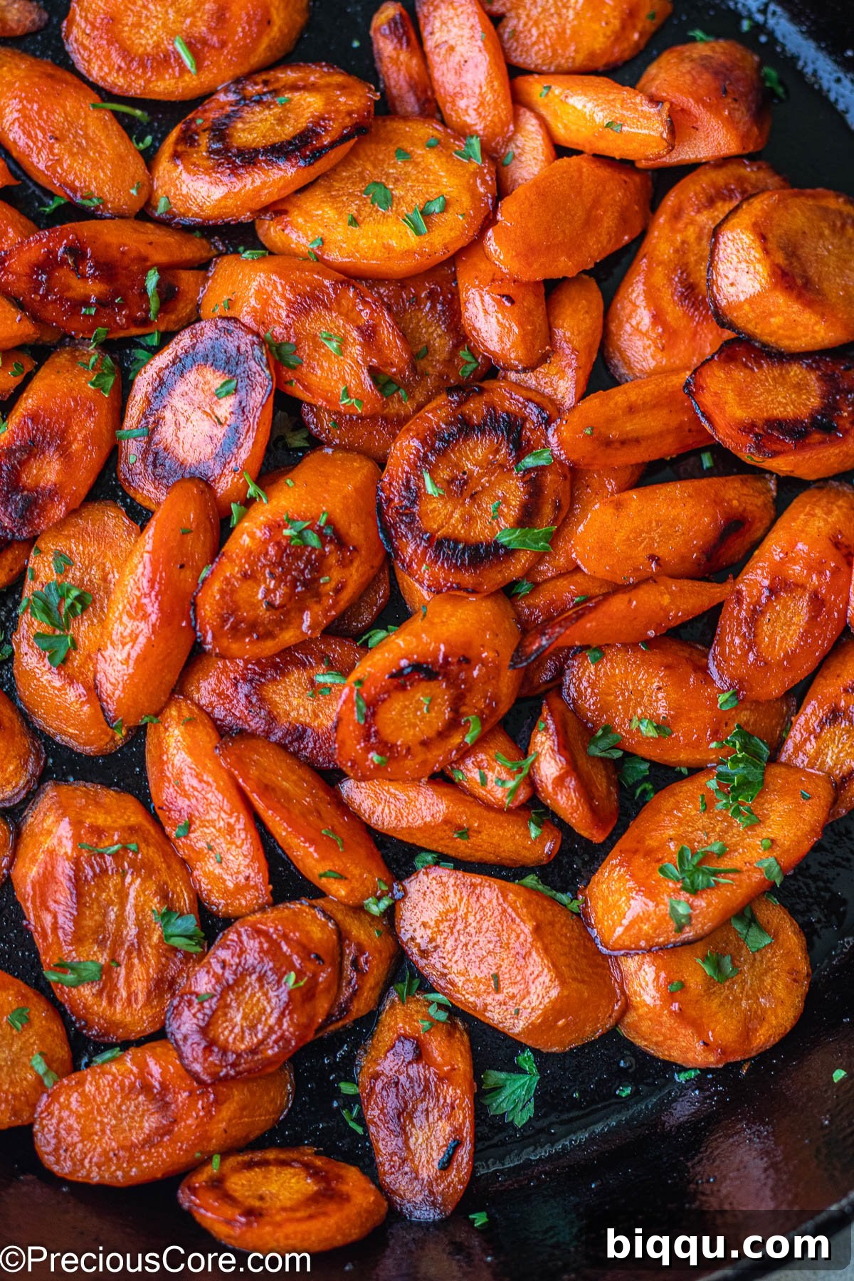 Fried Carrots in a cast iron skillet, a delicious accompaniment for roast chicken.