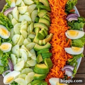 Lettuce, cucumbers and other vegetables on a platter for a fresh salad.